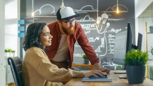 man and woman look at computer together to repersent co-managed IT services