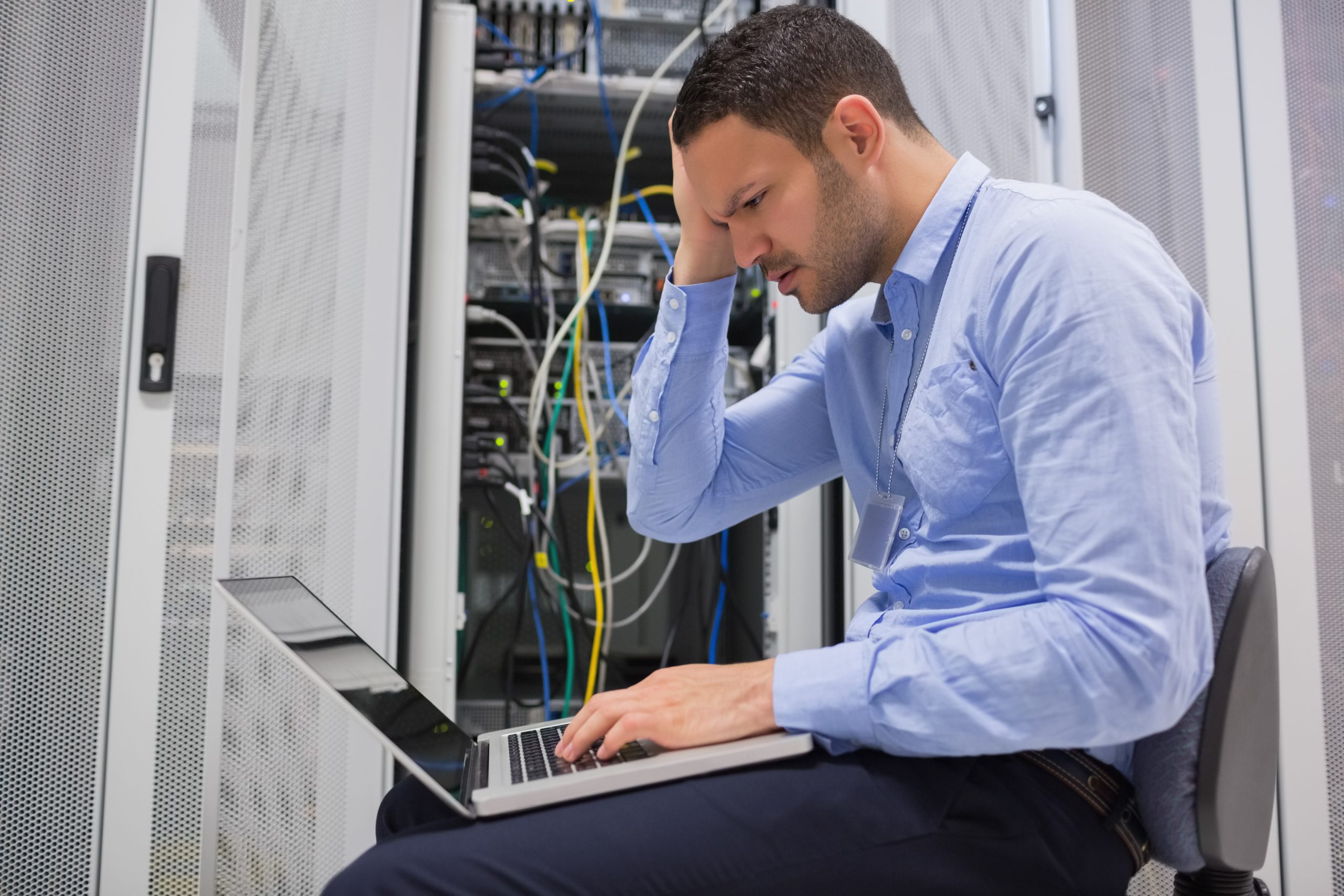 Technician becoming stressed over servers in data center of IT provider