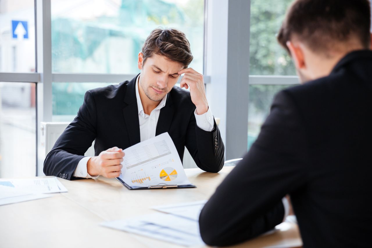 two men reviewing business planning documents