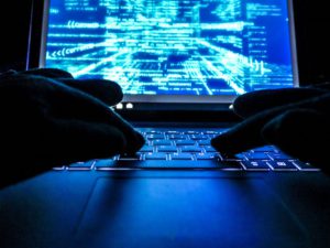 hacker on computer searching dark web